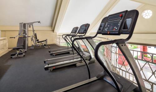 a row of treadmills in a gym with machines at Condotel in Pasig City - Hampton Gardens in Manila
