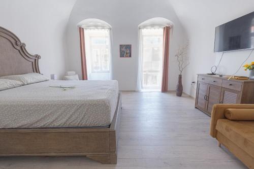 a bedroom with a bed and a dresser and two windows at Penzión Rosenau in Rožňava