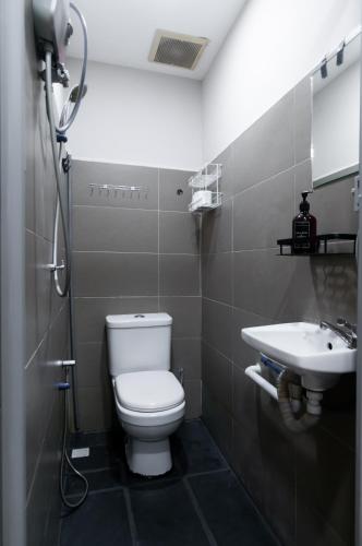 a bathroom with a toilet and a sink at Aayu Muntri - 4 mins to Chulia St George Town in George Town