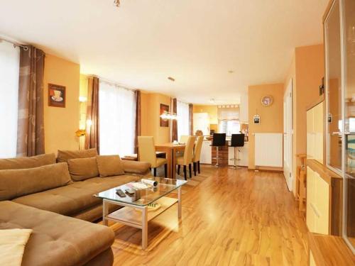 a living room with a couch and a table at Schwannest 1 in Groß Schwansee