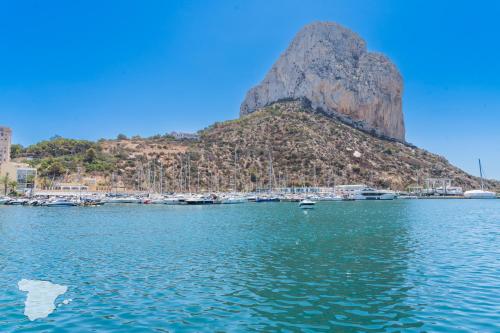 a view of a mountain with boats in the water at CostaBlancaDreams Casa Narciso in Calpe in Empedrola