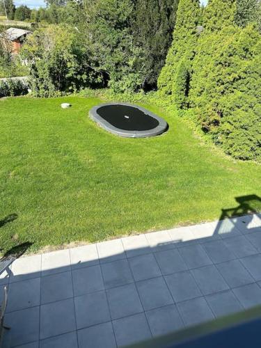 a view of a park with a hole in the grass at Helt nyt hus i idyllisk landsby in Vallensbæk