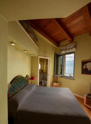 a bedroom with a large bed and a window at Casa Pazzi Dimora d'Epoca in Grottammare