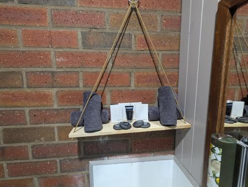 a shelf with speakers on a brick wall at Kyabram Country Motel in Kyabram