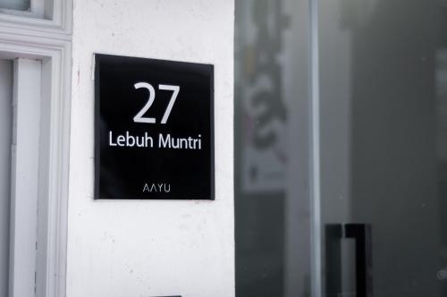 a sign on the side of a building with the number at Aayu Muntri - 4 mins to Chulia St George Town in George Town