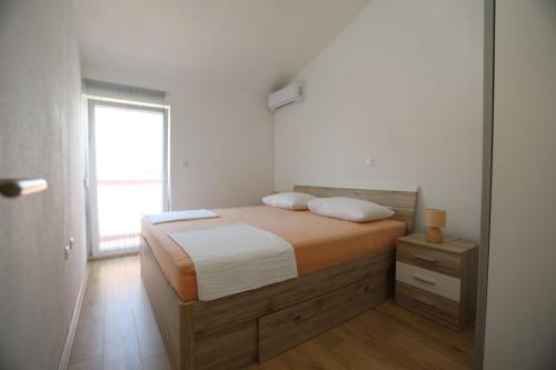 a bedroom with a bed and a window at Surf & joy - Croatia vacation rentals seaview apartment in Okrug Gornji
