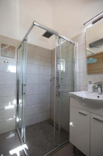 a bathroom with a shower and a sink at Surf & joy - Croatia vacation rentals seaview apartment in Okrug Gornji
