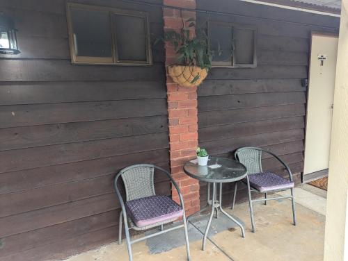 two chairs and a table on a patio at Kyabram Country Motel in Kyabram