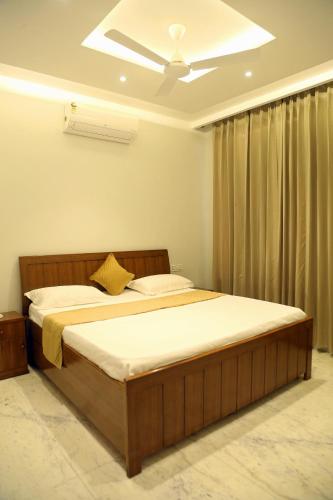 a bedroom with a large bed with a ceiling at Cosy Cottage in Chandīgarh