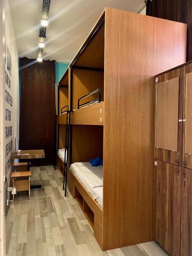 a room with bunk beds and a desk in it at Central Hostel in Sheki