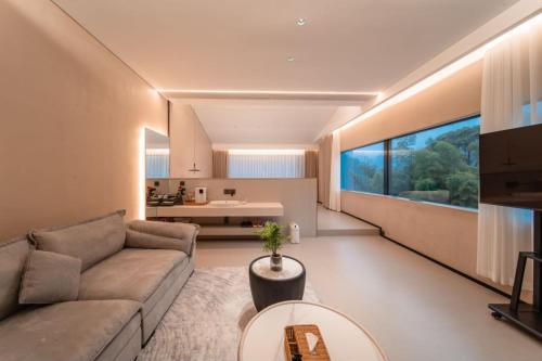 a living room with a couch and a table at 云漫山居民宿 in Xinglong