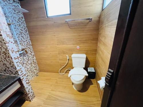 a bathroom with a white toilet in a room at Na Thapae Chiangmai Hotel in Chiang Mai