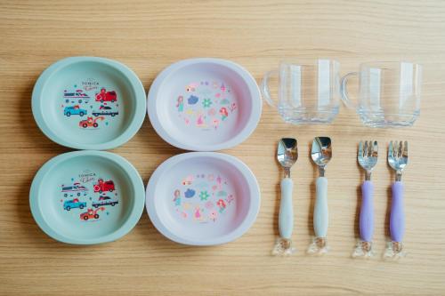 a table with plates and forks and spoons at moon hakone in Hakone