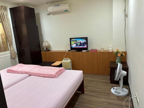 a hospital room with a bed and a television at 今友緣二館民宿 in Dongyin