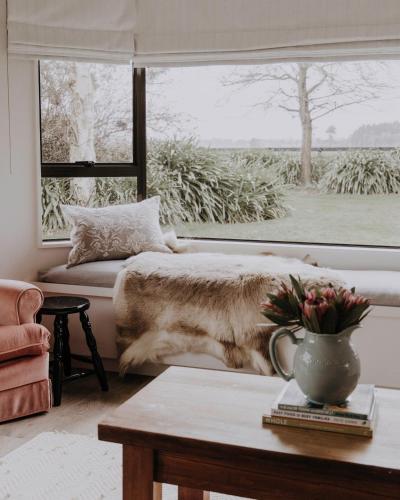 a bedroom with a bed and a large window at Moomaa Stay in Marton