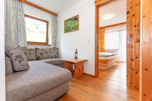 a living room with a couch and a table at Seetalhof in Hollersbach im Pinzgau