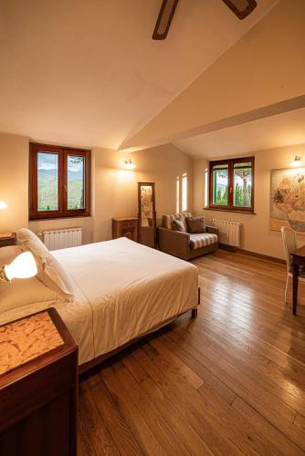 a large bedroom with a large bed and a couch at Agriturismo La Cerra in Tivoli