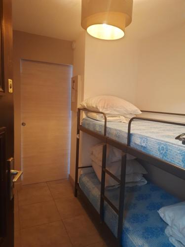 Cette chambre comprend 2 lits superposés et une porte. dans l'établissement L'attrape rêves du Cap d agde, au Cap d'Agde