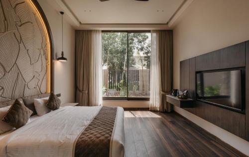 a bedroom with a large bed and a large window at Luxury Lofts in Amritsar
