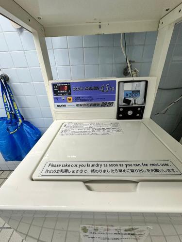 a machine in a room with a sign on it at エルザビル711 in Sumiyoshi