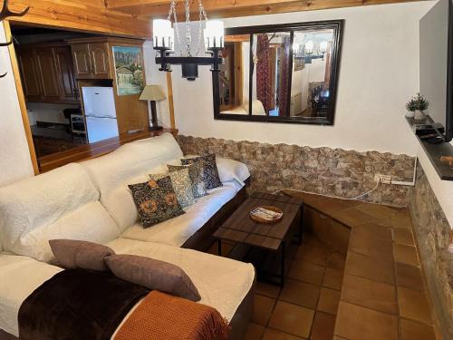 a living room with a couch and a table at Casa rural C de Caballo, Valdorria Brother Law SL in Valdorria