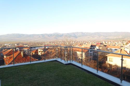 a balcony with a view of a city at ENIS Hotel с минерален басейн in Sapareva Banya