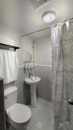 a bathroom with a toilet and a sink at Harmonious Hideaway in Lapu Lapu City