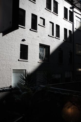 a tall white building with a lot of windows at Collins Paris End suite- 2 bedrooms with balcony in Melbourne