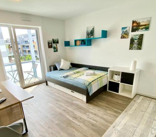 Postel nebo postele na pokoji v ubytování Carefree Mikroapartment inkl. Balkon + Tiefgarage