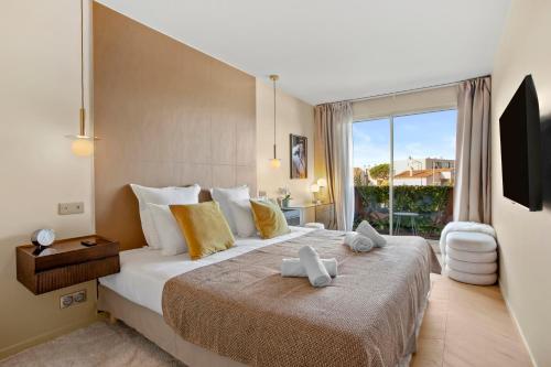 une chambre avec un grand lit avec une grande fenêtre dans l'établissement Magnifique appartement St Tropez, à Saint-Tropez