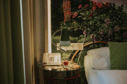 a table with a phone next to a window at Boutiquehotel Stadthalle in Vienna