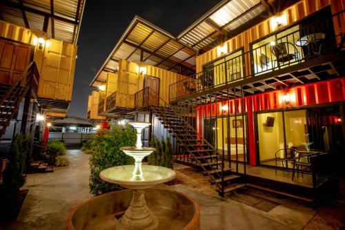 a building with a staircase in the middle of it at Tuscany Land Resort Donmuang in Bangkok