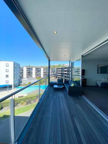 a view of a balcony of a building with a couch at Modern Apartment With Pool and Gym in Napier