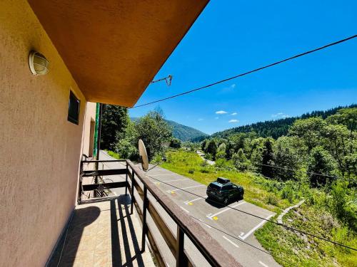 a car driving down a road from a balcony at Pensiunea Roua in Sinaia
