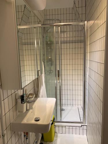 une salle de bain blanche avec une douche et un lavabo dans l'établissement Super Apartment, comfort design functional, à Paris