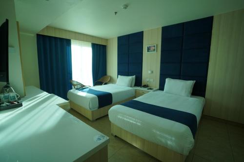 Postel nebo postele na pokoji v ubytování Al Fanar Azur Hotel