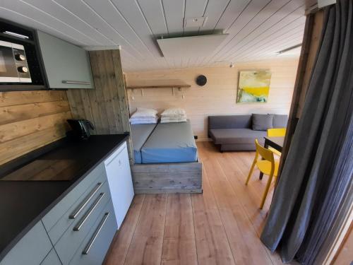 a kitchen and living room of a tiny house at Guldborg Camping & Cottages - Superior in Guldborg