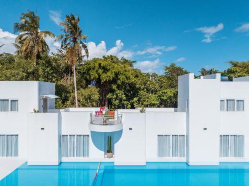 a view of the side of a building with a swimming pool at The Up Hotel Phu Quoc Island - The Poolside Escape in Phu Quoc