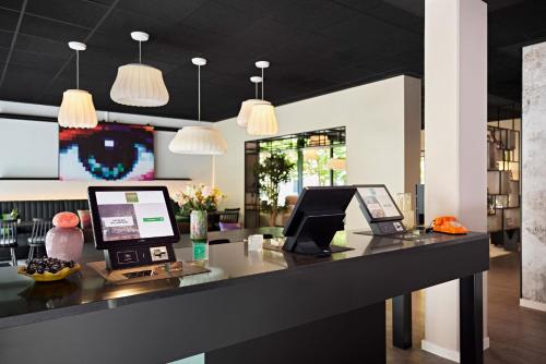 a desk with two computers on top of it at LÉGÈRE EXPRESS Tuttlingen in Tuttlingen