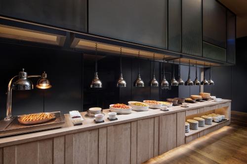a buffet line with many different types of food at Shilla Stay Dongtan - Samsung Digital City in Hwaseong