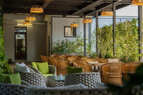 a restaurant with wicker chairs and tables and lights at Holiday Inn Telavi by IHG in Tʼelavi