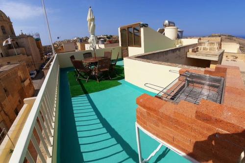 a view from the roof of a building with a green floor at Lovely Home with Private Terrace in Zebbug, Gozo by 360 Estates in Żebbuġ