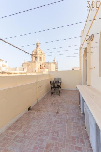 a view from the roof of a building with a bench at Lovely Home with Private Terrace in Zebbug, Gozo by 360 Estates in Żebbuġ