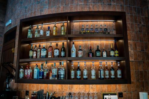 a wall with many bottles of alcohol on it at Wellness Hotel Gyula in Gyula