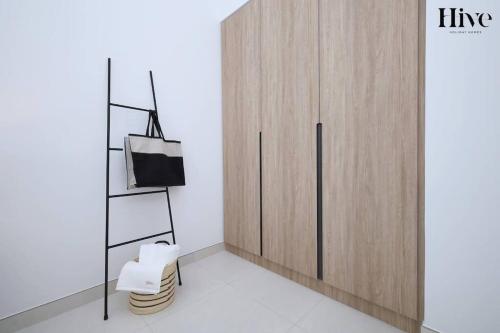a room with a wooden cabinet and a chair at 7 By Aurora 101 in Dubai