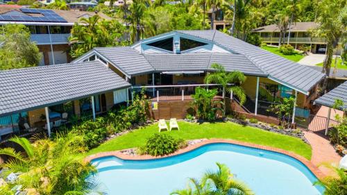 an aerial view of a house with a swimming pool at Diggers Beach Surf House - Pool, Surf Beach, Pets, Sleeps 10 in Coffs Harbour