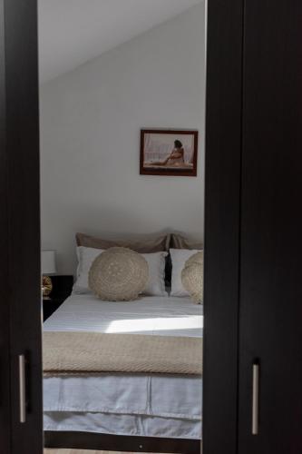 a bedroom with a bed with white sheets and pillows at Enjoy Apartments - Central Skylight Residence in Cluj-Napoca