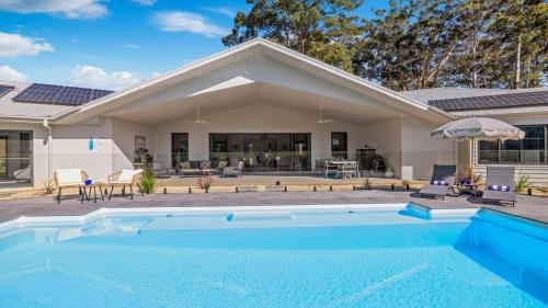 a swimming pool in front of a house at Koala Lane - Family, Pool, Sleeps 10, Luxe in Bonville