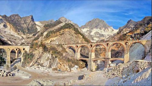 a bridge over a river with mountains in the background at Orizzonte spezzino in La Spezia