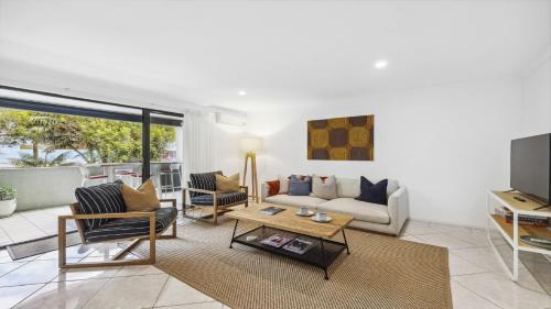 a living room with a couch and a table at Lindy Lou's - Village at Doorstep, Restaurants in Sawtell